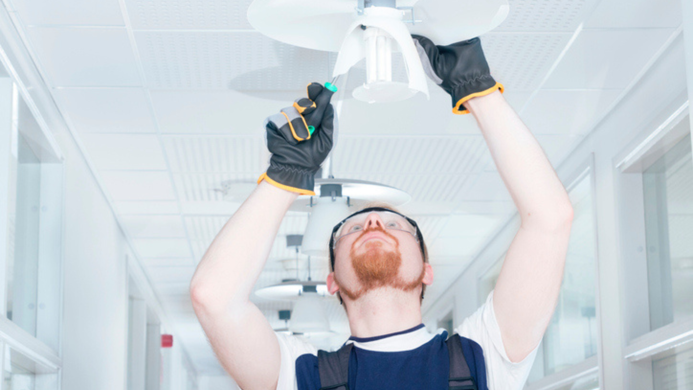 Man working on a ceiling light fixture